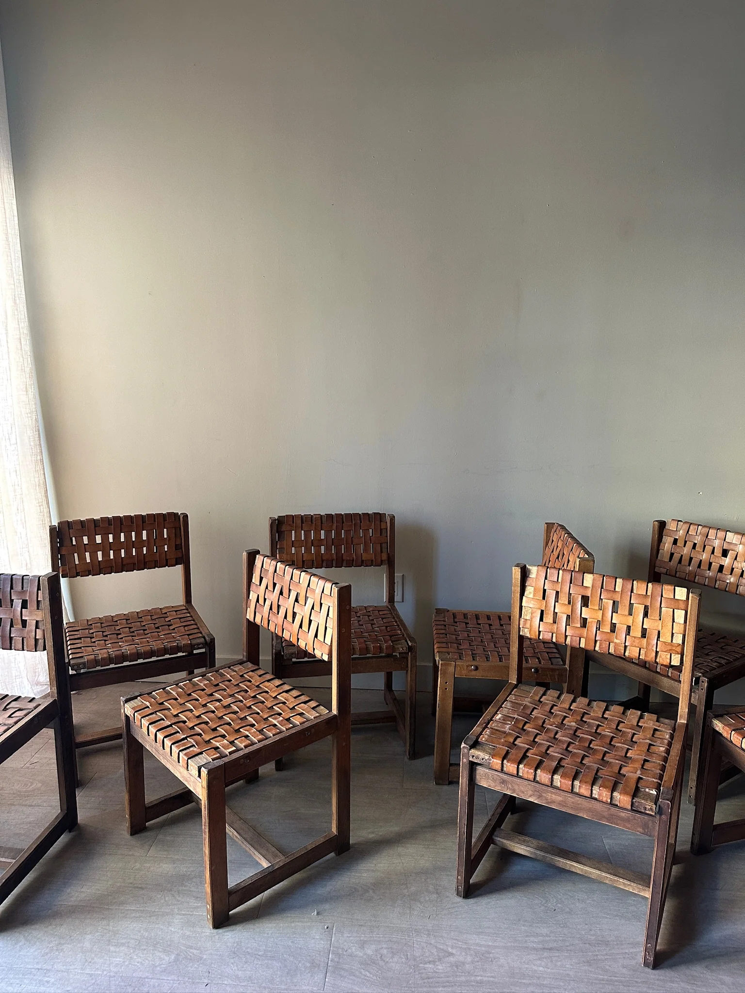 10 1970s woven leather dining chairs. Sold individually.