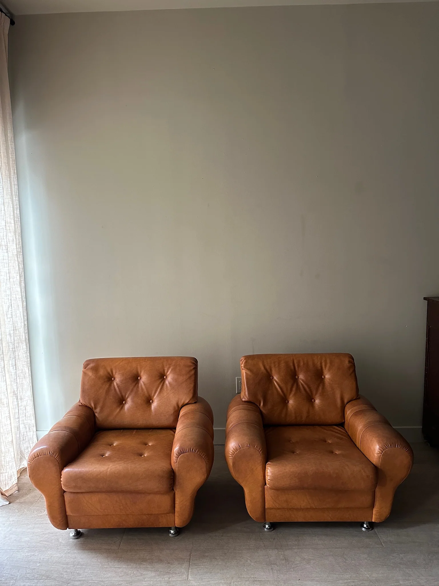 2 brown vinyl club chairs. Sold individually.