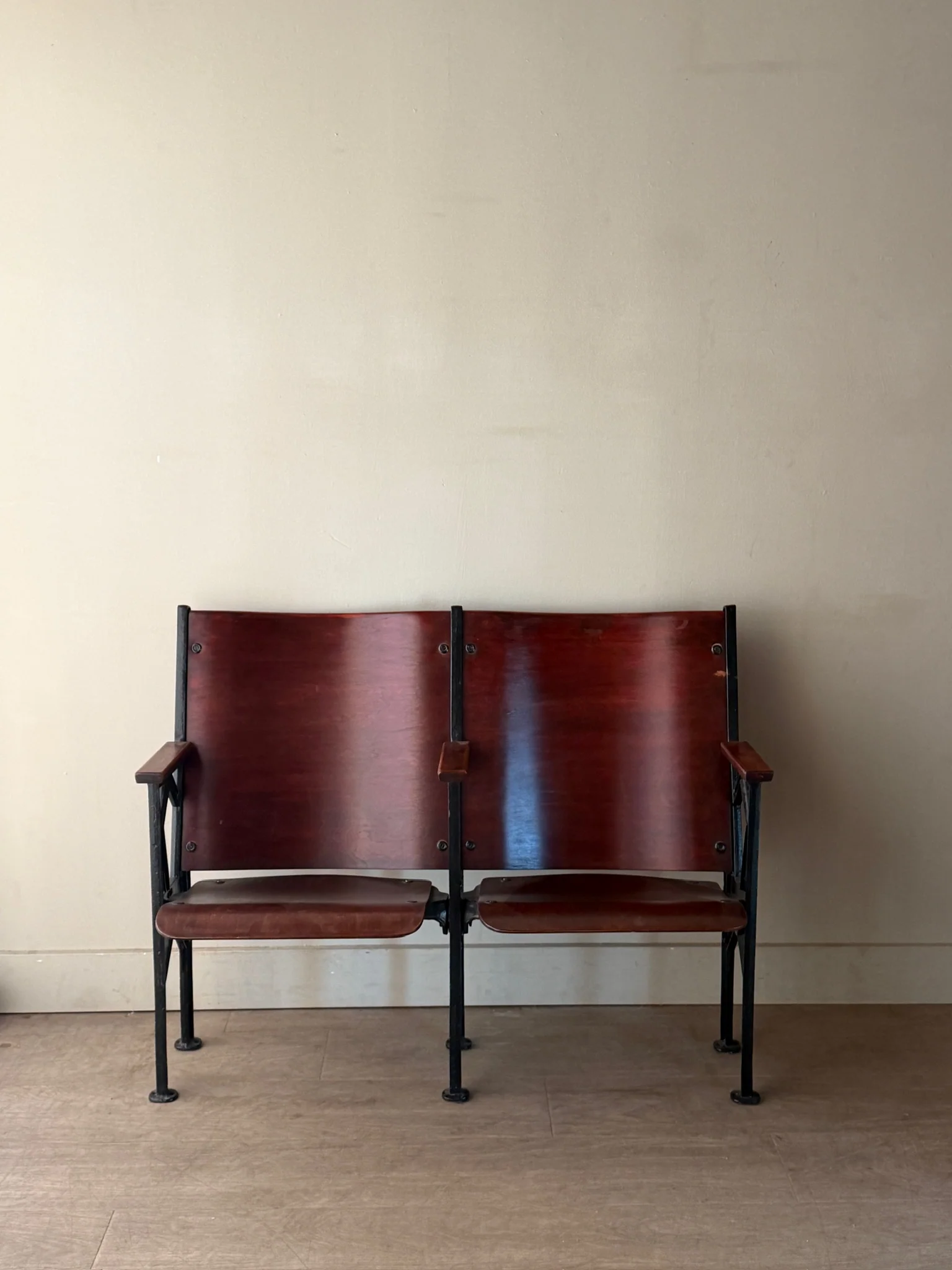 Cast iron and bentwood two-seat folding theater bench