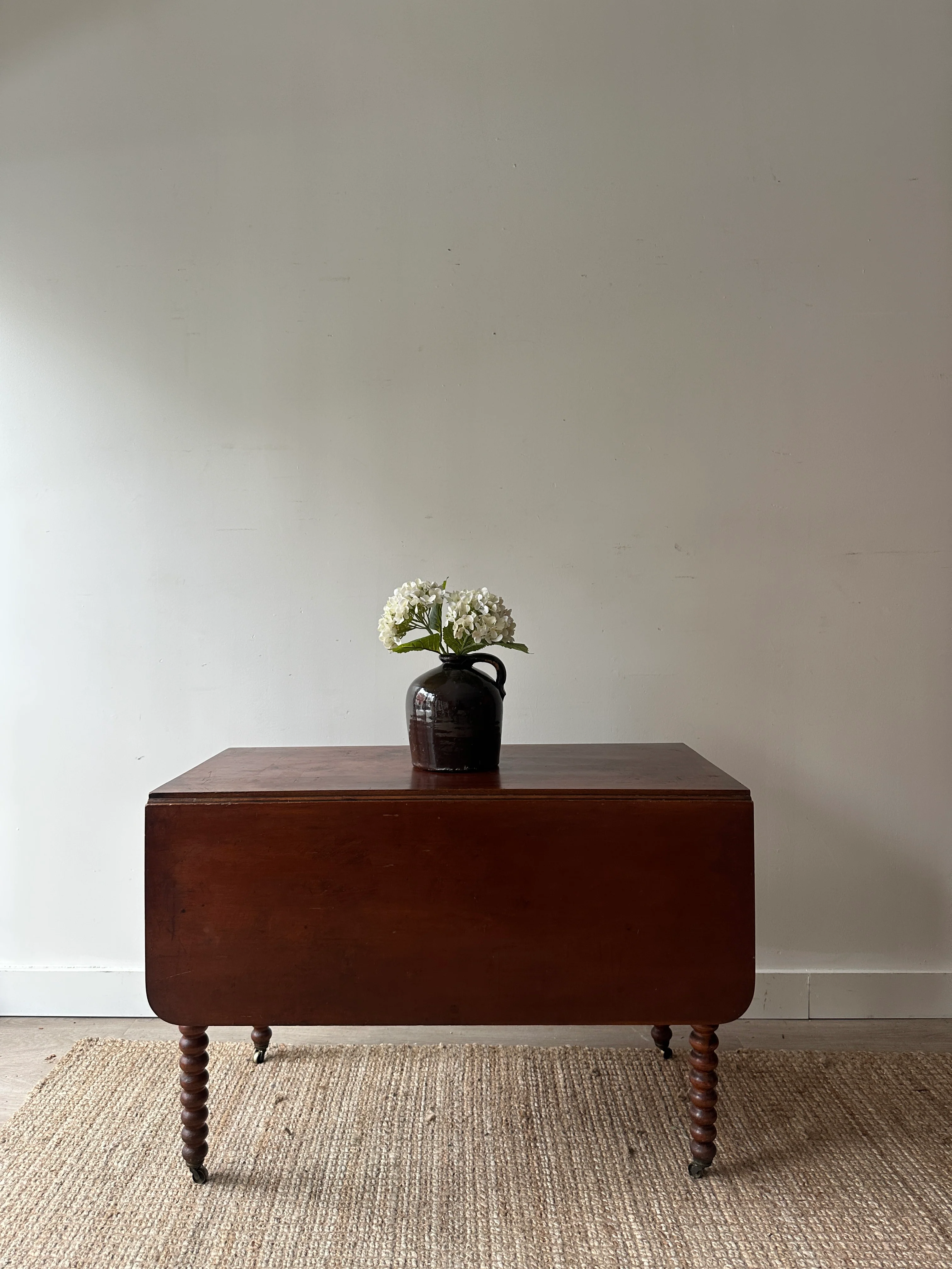Cherry drop leaf table with bobbin legs.