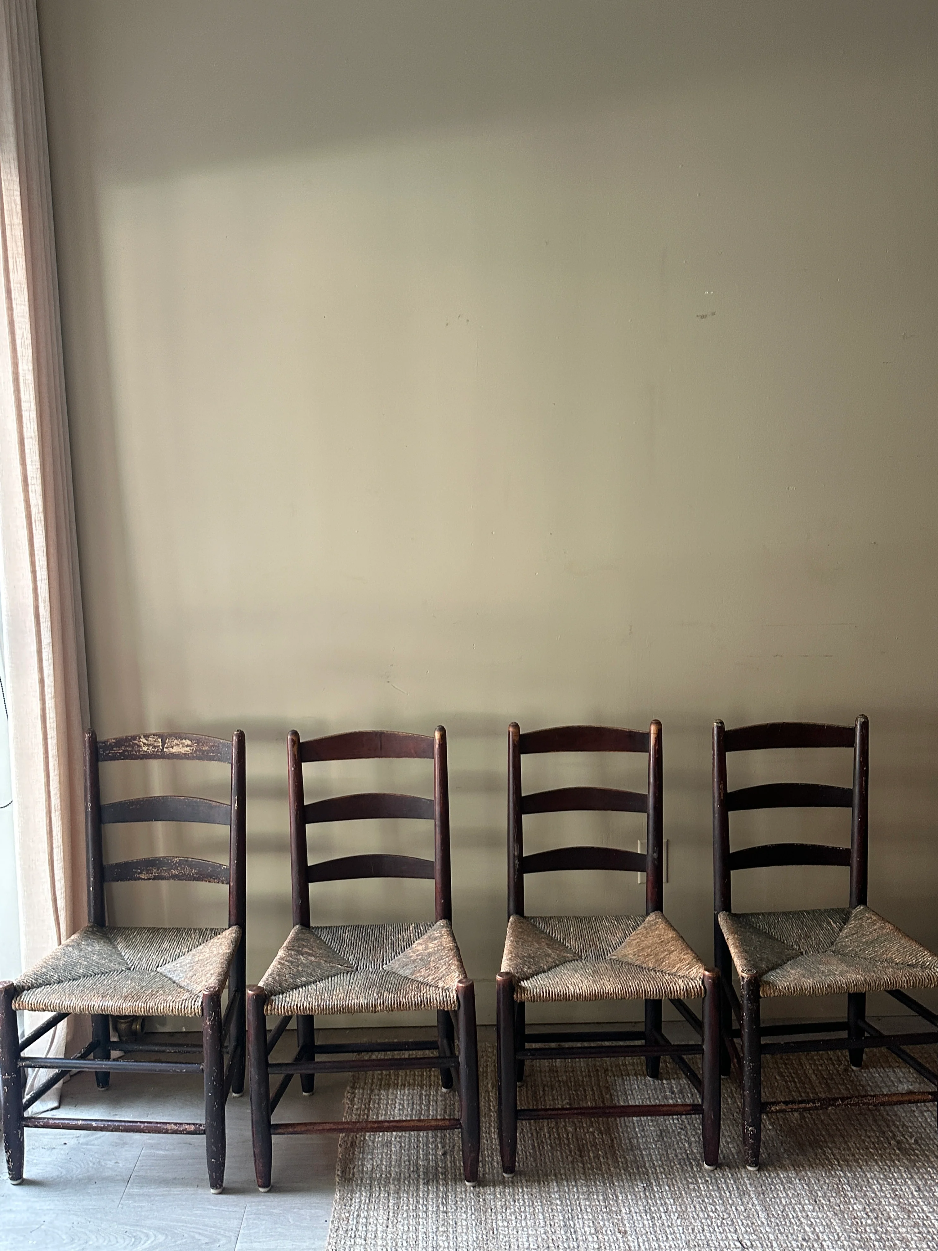Ladder back rush seat chairs. Sold in pairs.