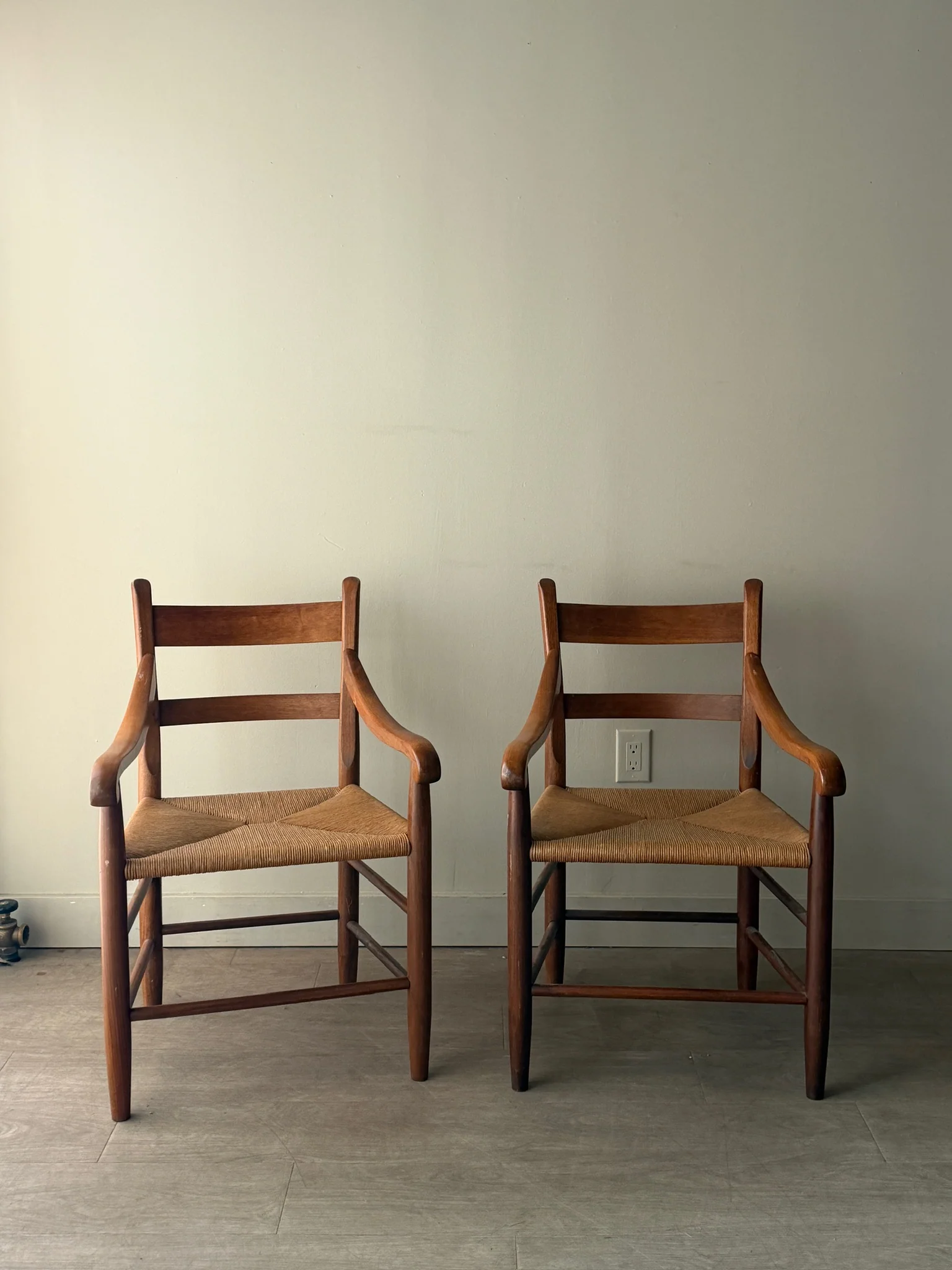 Pine rush seat dining chairs with arms. Sold as a pair.