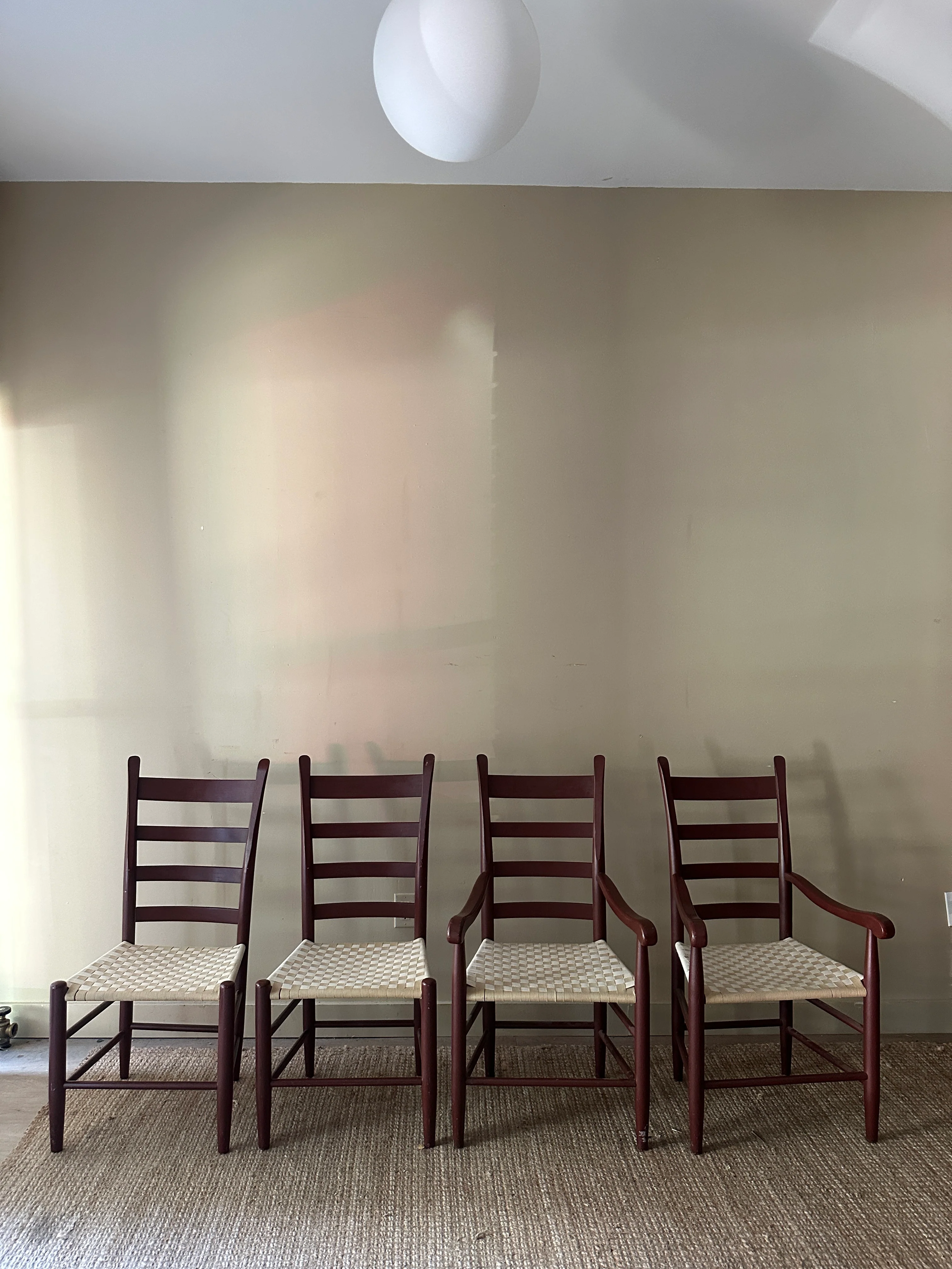 Woven chairs with arms. Sold as a pair.